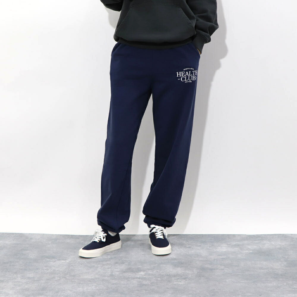 スポーティー&リッチ Sporty&Rich ボトムス ロングパンツ ユニセックス ネイビー コットン 裏起毛 メンズ レディース ロゴプリント スウェットパンツ SRB1PT206