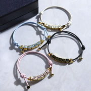 PRADA ブレスレット ブラック ホワイト ライトブルー ライトピンク ロゴ エナメルメタル 1IB522 038