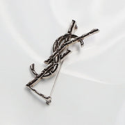 SAINT LAURENT ブローチ OPYUM Y1500 カサンドラロゴ